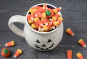 A white mug full of candy corn