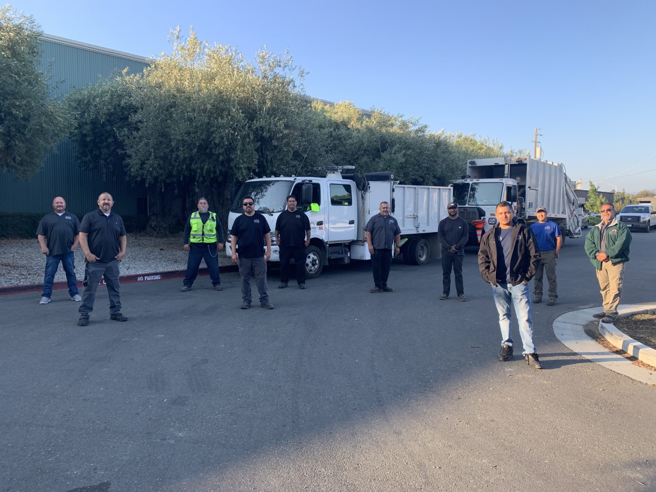 BeautifySJ's RAPID team poses for a photo. Social distanced with their trucks in the background.