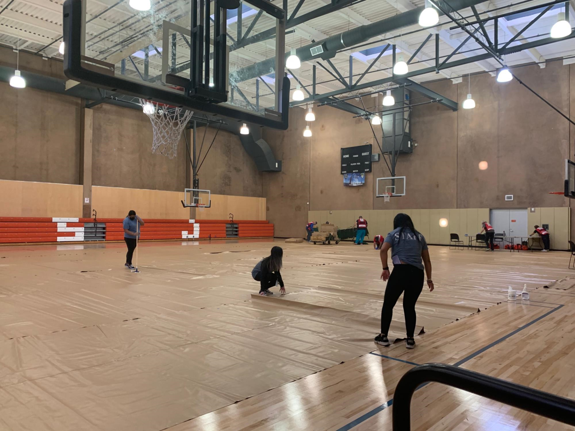 Bascom Community Center staff setting up their basketball court for the evacuation activation