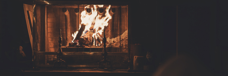 An active fireplace in a dark room.