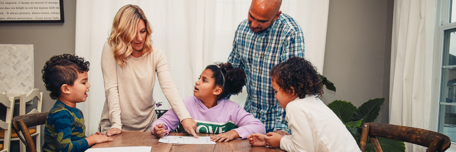 A family working together on a wildfire action plan on a dining table.