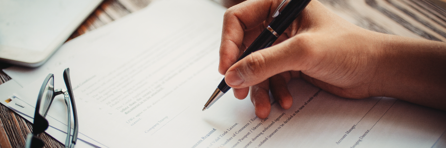 A person signing some forms.