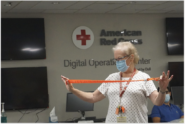 Red Cross instructor demonstrating how to use a tourniquet during a first aid class