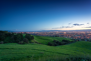 Rolling green hills and a darkening sky taken at dusk