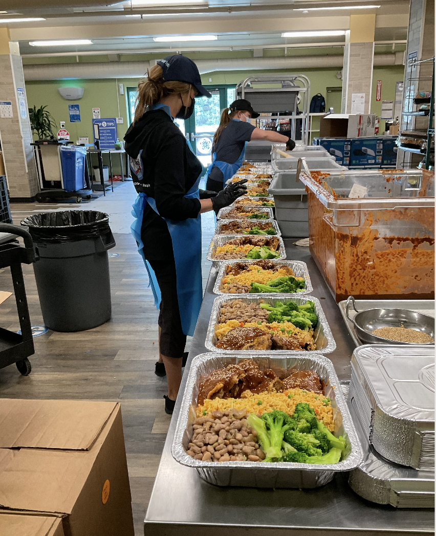 Volunteer assembling pre-made meals for distribution