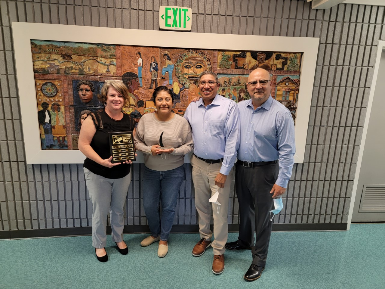 Hilda Morales receiving Danny Perez award alongside her supervisors