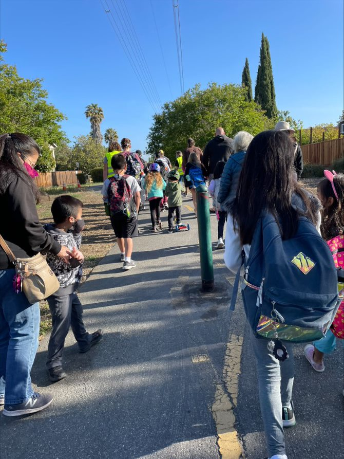 Students and families participating in a walking school bus