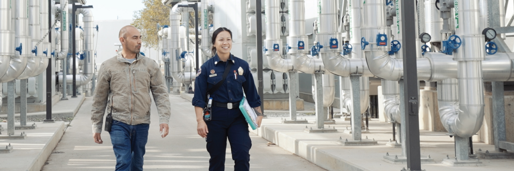 An SJFD fire inspector walking with a customer.