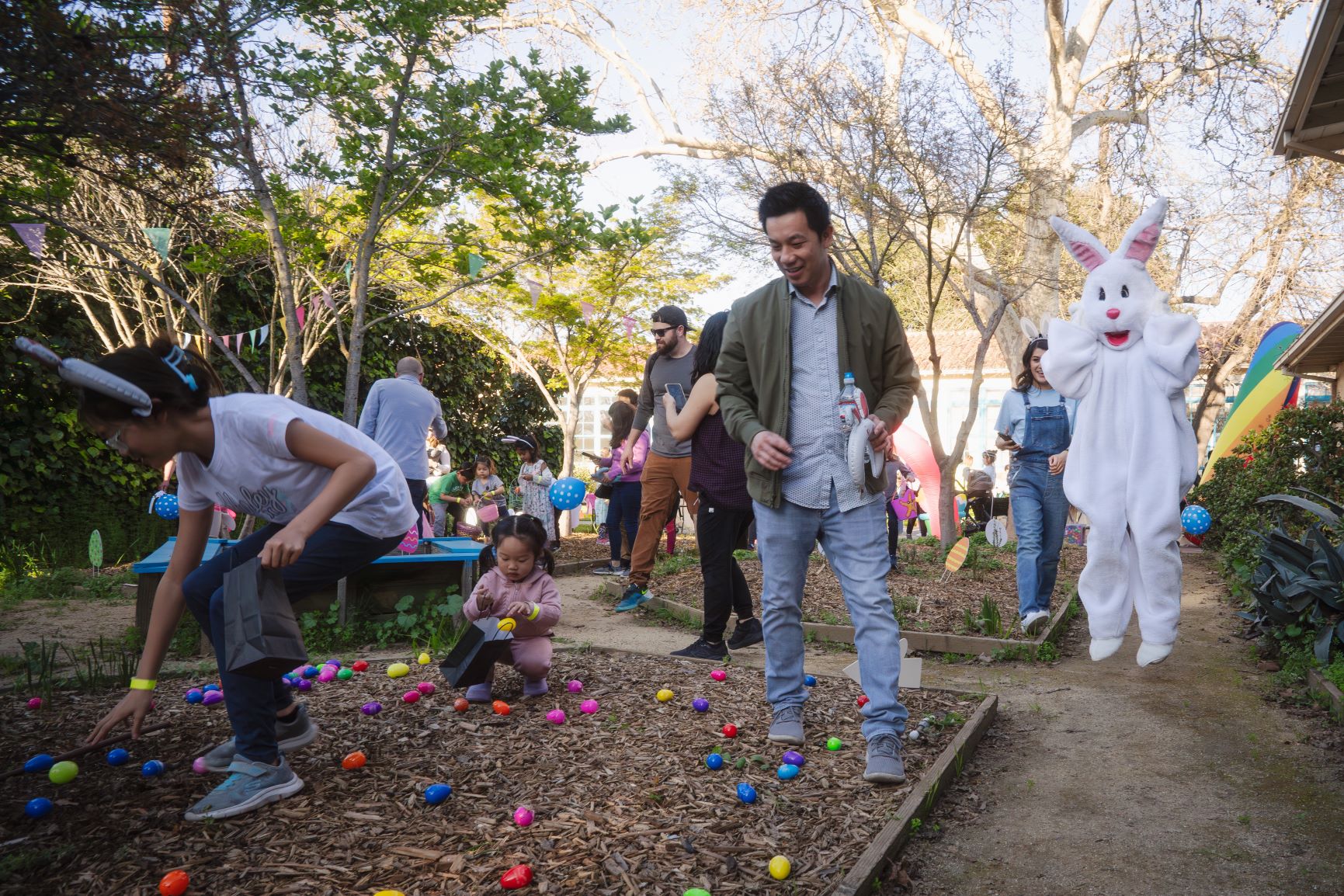 Children and their families gathering Easter eggs at the Willow Glen Community Center garden.