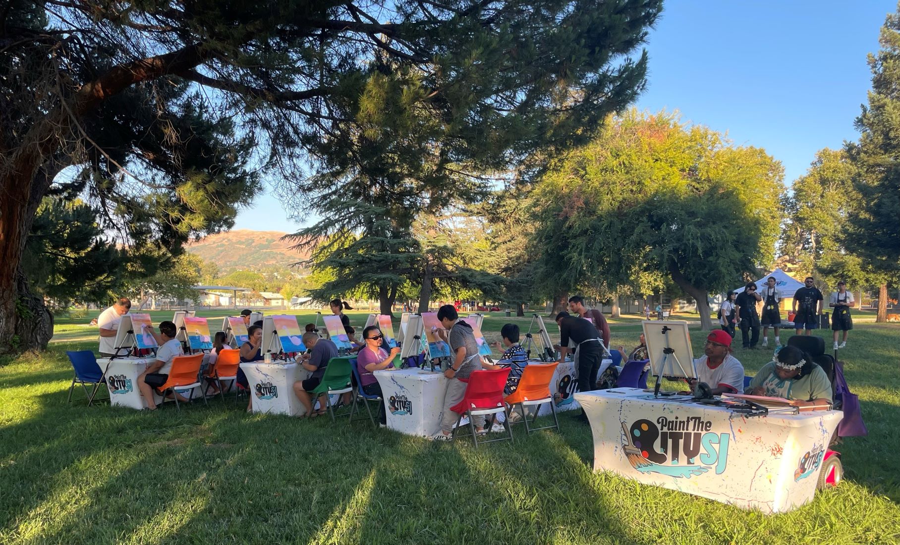 Residents are seated for a live painting demonstration at Noble Park.