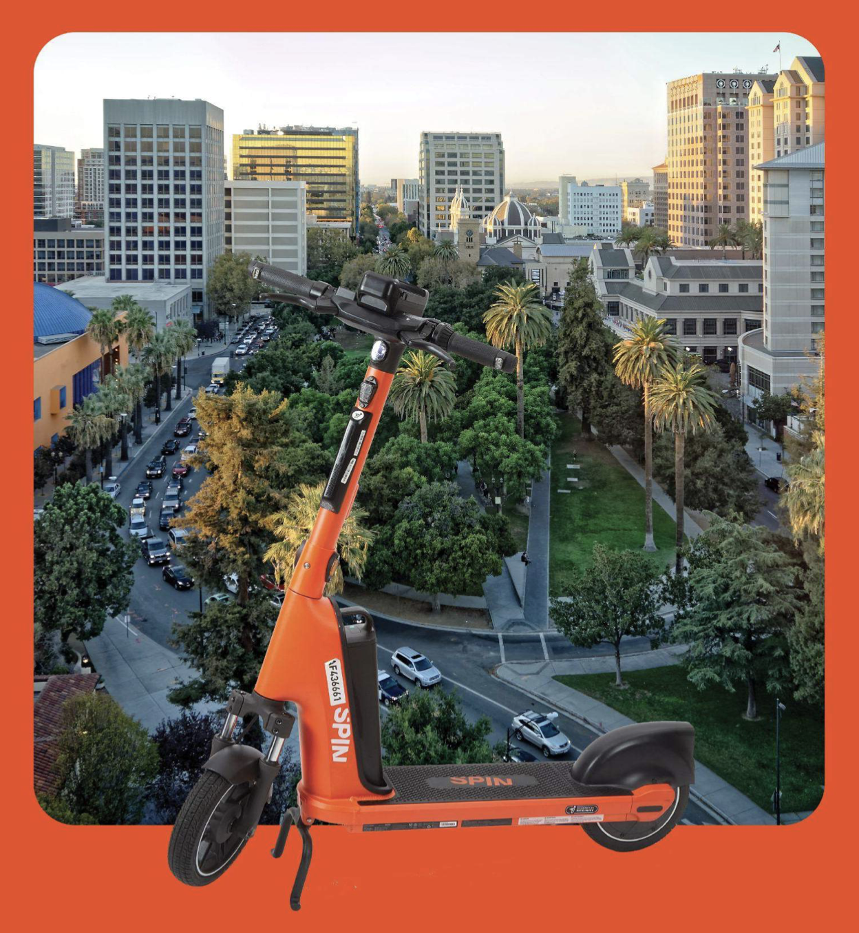 An orange Spin e-scooter with downtown San Jose as backdrop