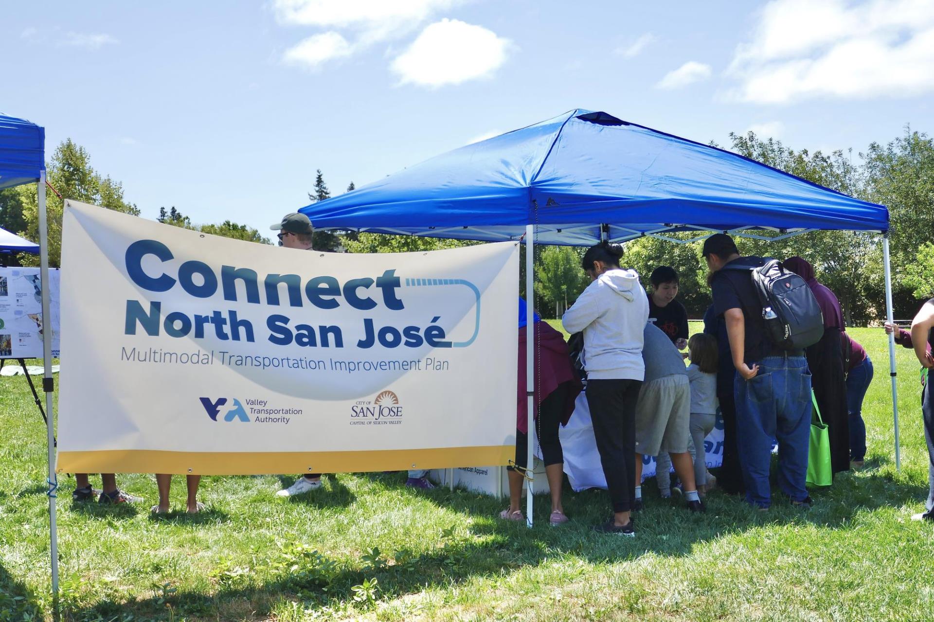 A Connect North San José booth at an outdoor event