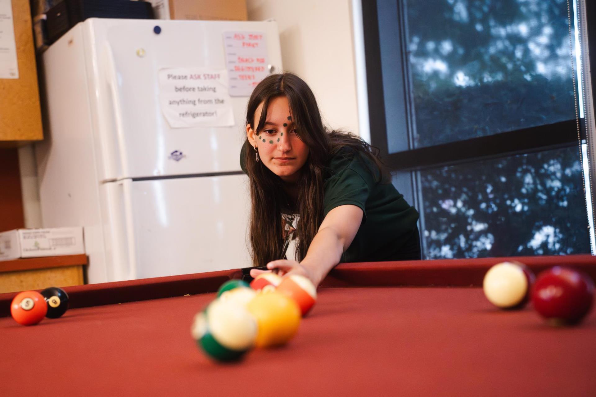 One teen participant plays pool Bascom’s Community Center’s Back-to-School Reopening Party.