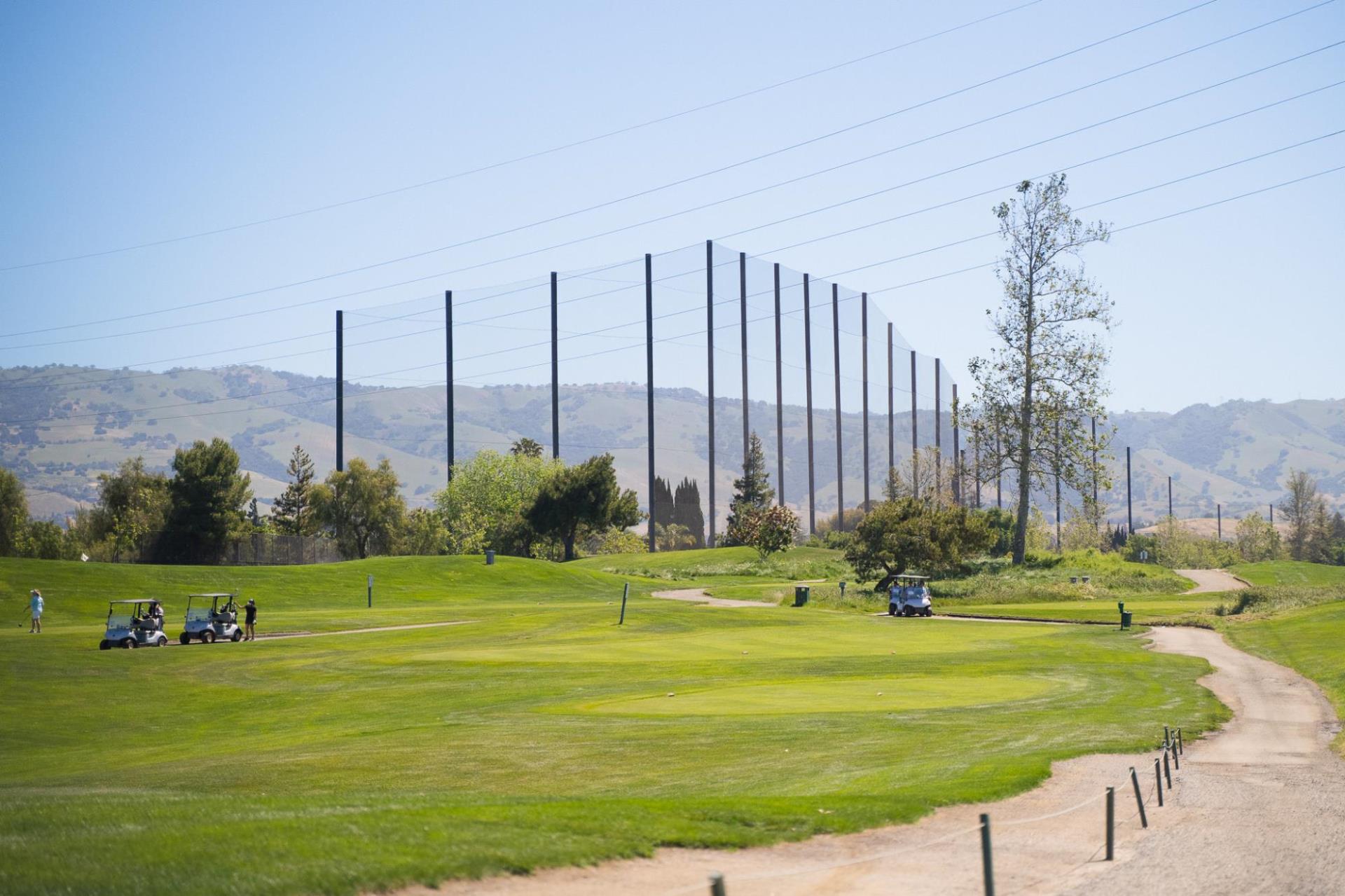 A wide shot view of Los Lagos Golf Course with a scenic mountain backdrop.