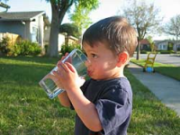 A little boy drinking some clean water.