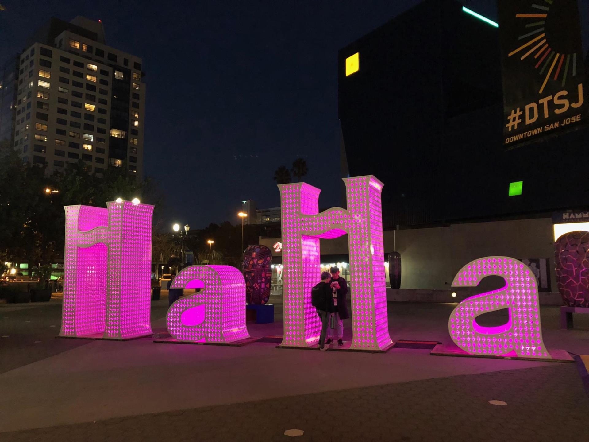 12 foot sculpture that spells "HaHa" installed at Hammer Theatre Plaza