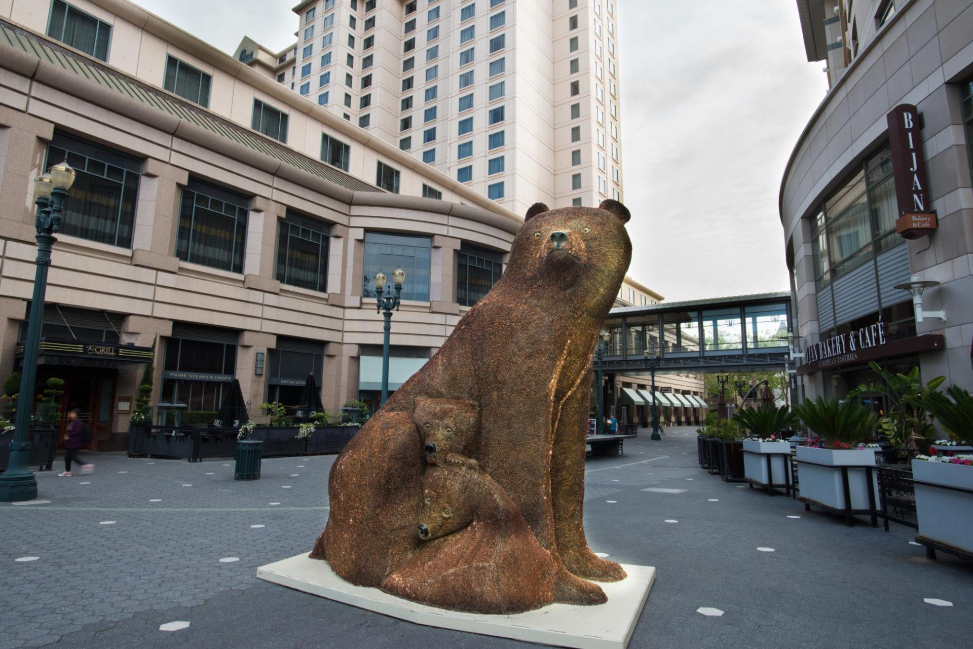 Sculpture of a mother bear and cubs made of pennies installed on Paseo de San Antonio