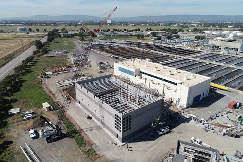 Cogeneration facility roof trusses are installed for new engine generation building